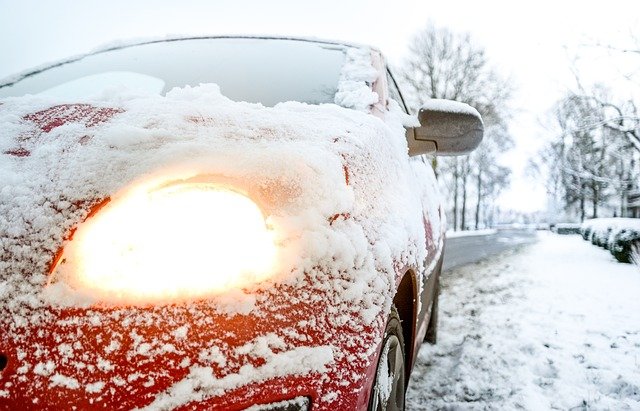 Getting Ready For Winter Driving 1 Red car driving on a heavy snowing day