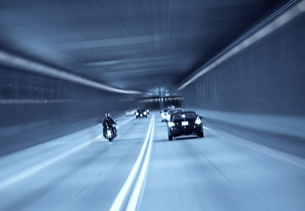 Top Causes of Motorcycle Accidents 1 Motorcycle is running in a expressway tunnel with cars aside